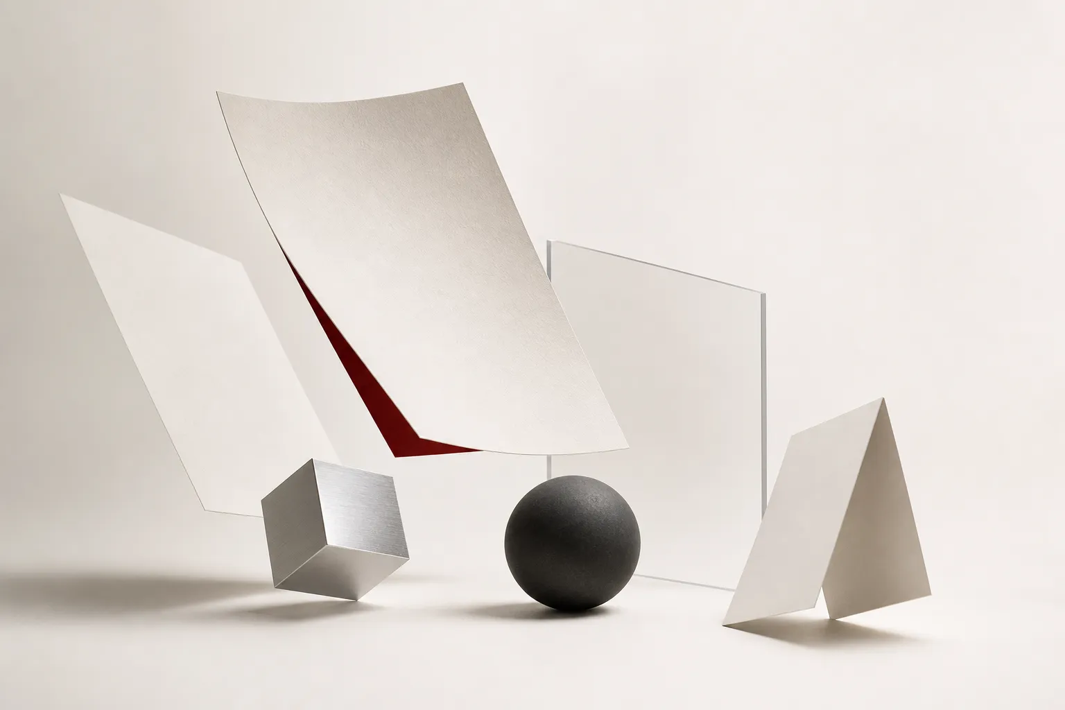 Minimal Studio hero still life with floating paper, metal, acrylic, and graphite objects